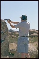 Chris fires a hand-cannon. 